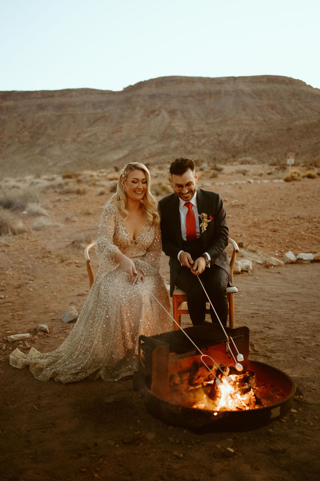Newlyweds roasting marshmallows in the fire pit for s'mores in the middle of ash springs  