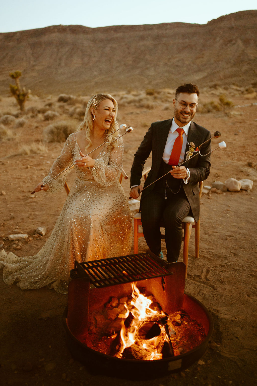 Newlyweds laughing at the fire pit from the marshmallows being extra crispy. 