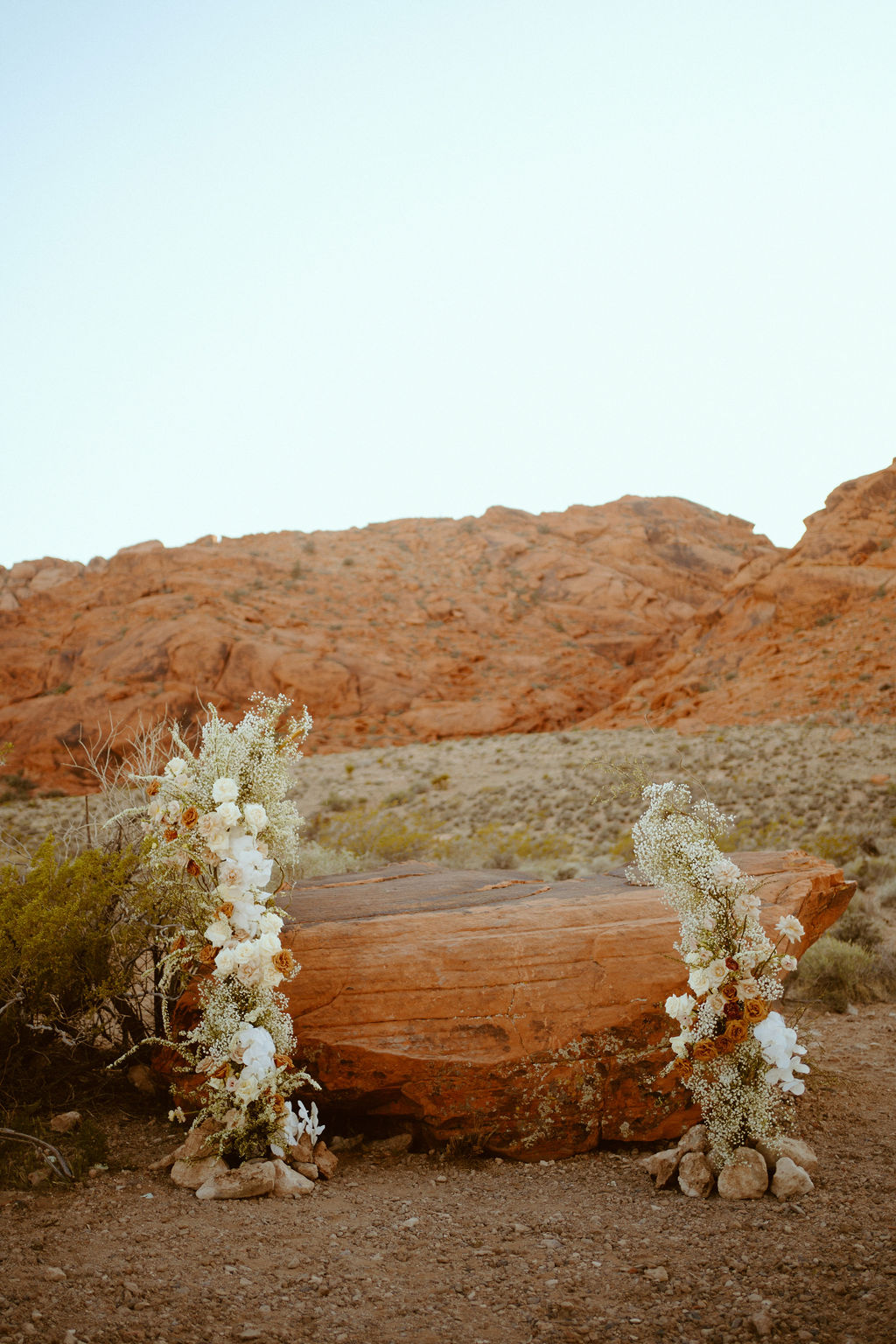 Micro-Wedding Reception at Ash Springs. Beautiful two piece flower alter in front of the red rocks of ash springs. 