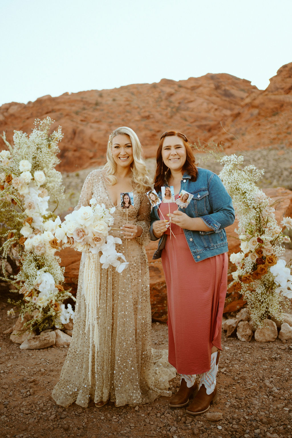 Bride with the maid of honor and photos of the bridesmaids who couldn't make it 