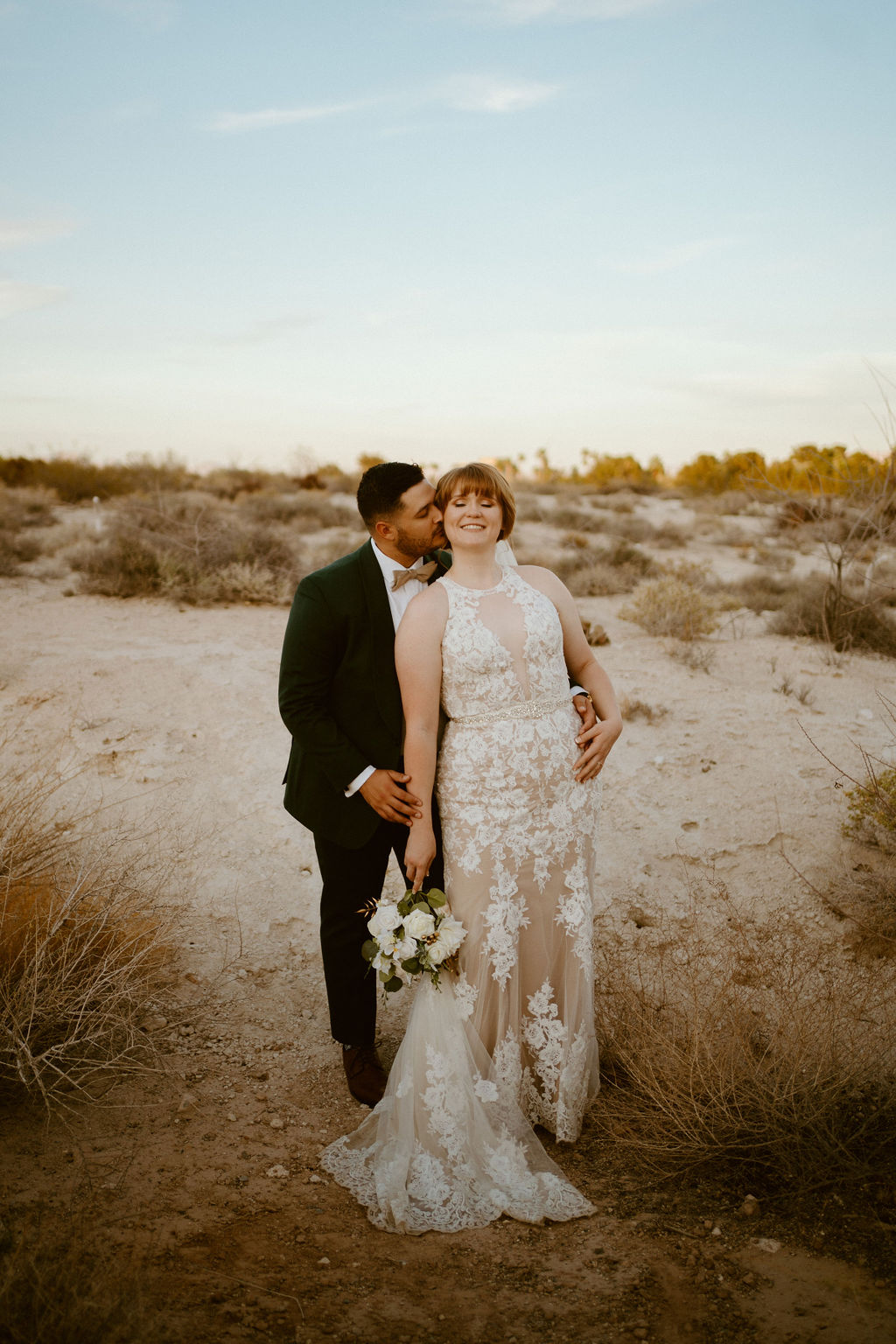 Groom kissing bride in the Las Vegas desert 