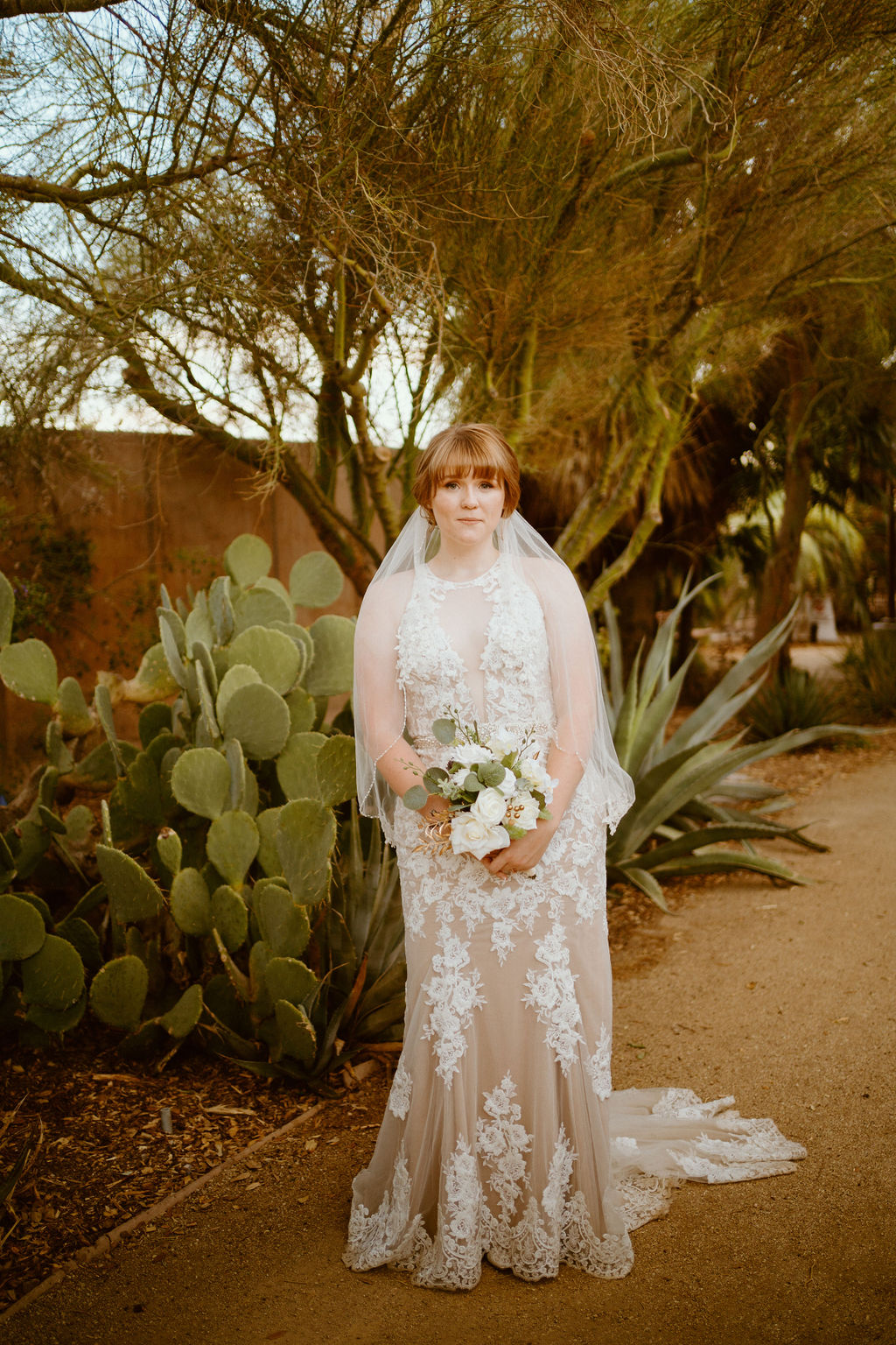 Bride which lace dress and simple white and sage bouquet 