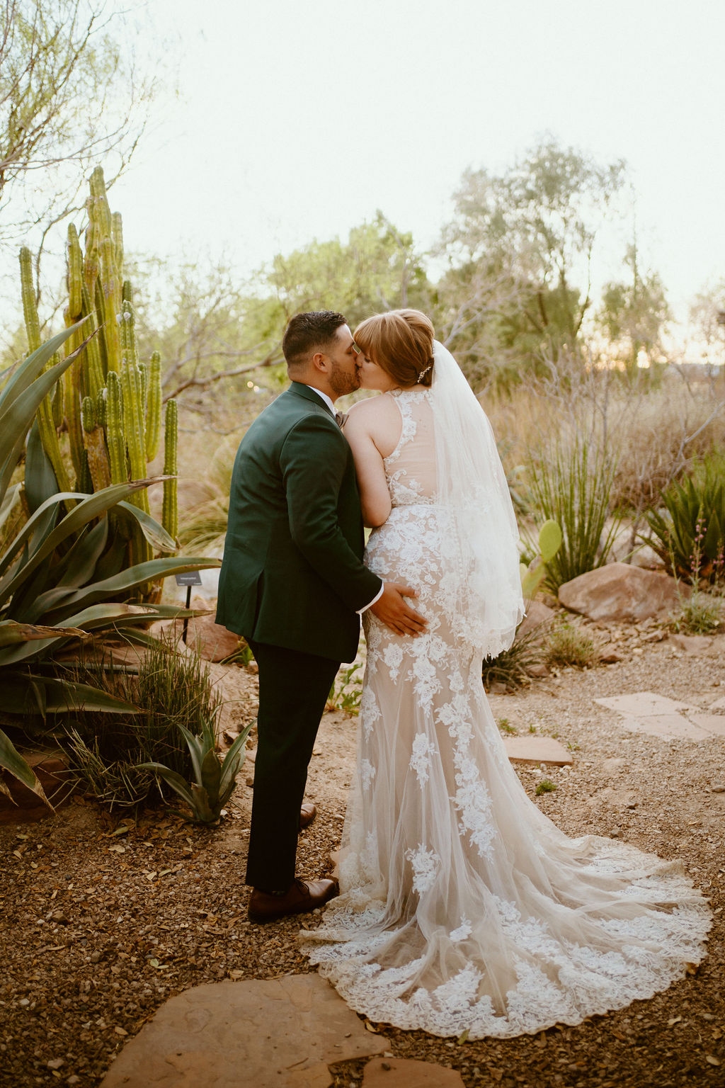 Newlyweds kissing in cactus garden for Springs Preserve Greenery Elopement