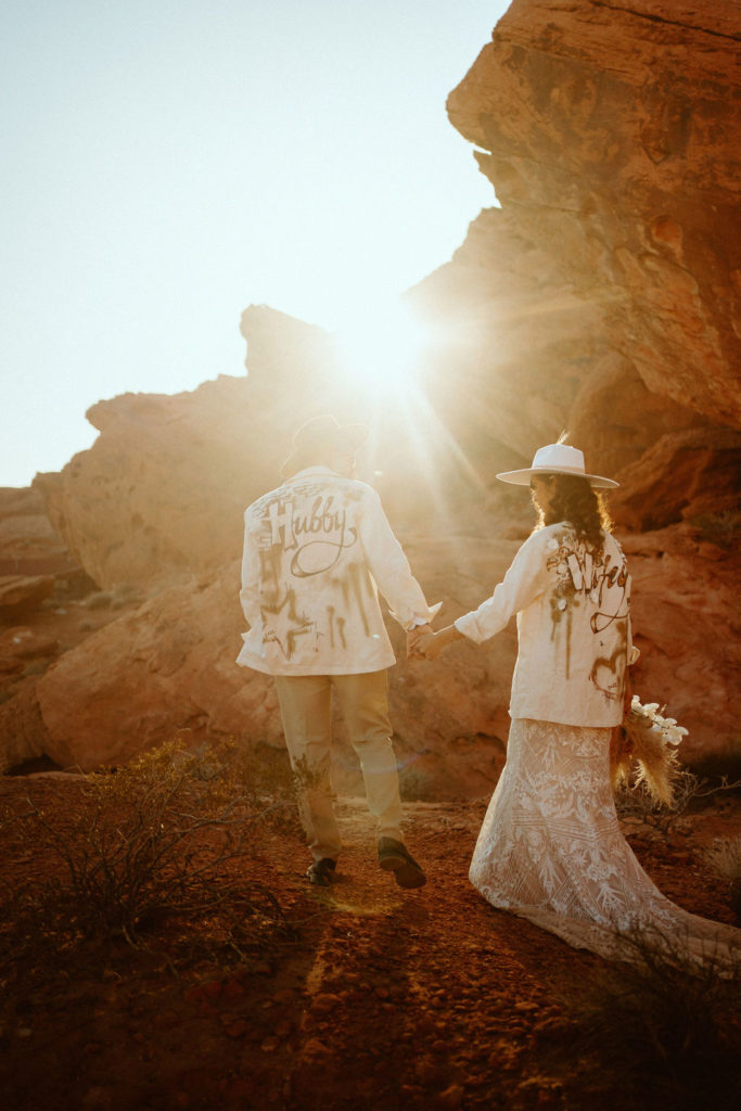Bride and groom in valley of fire with white custom jackets 