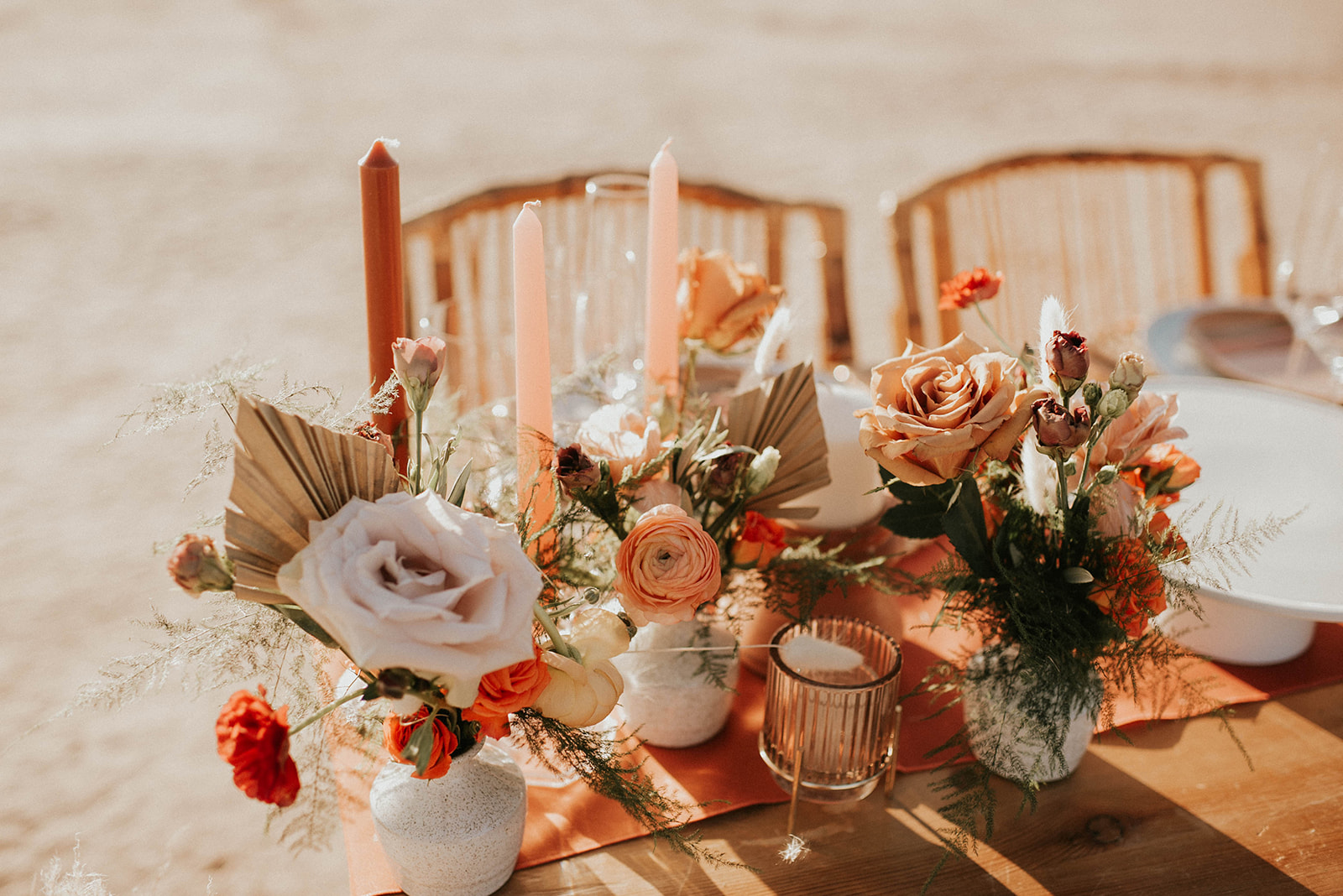 Close up of the sweetheart table with boho florals and candles. 
