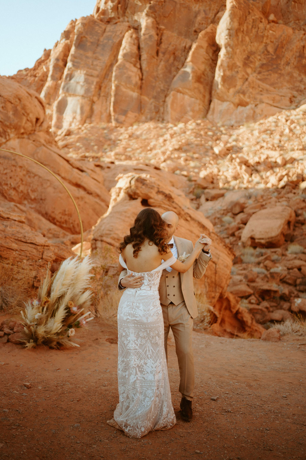 Newlyweds dancing in desert 