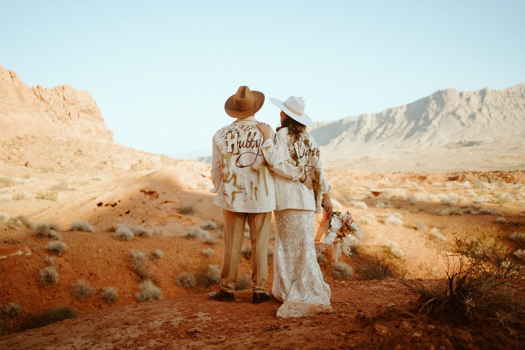 Couple wearing Hubby & Wifey Custom Jackets in Valley of Fire after Elopements 