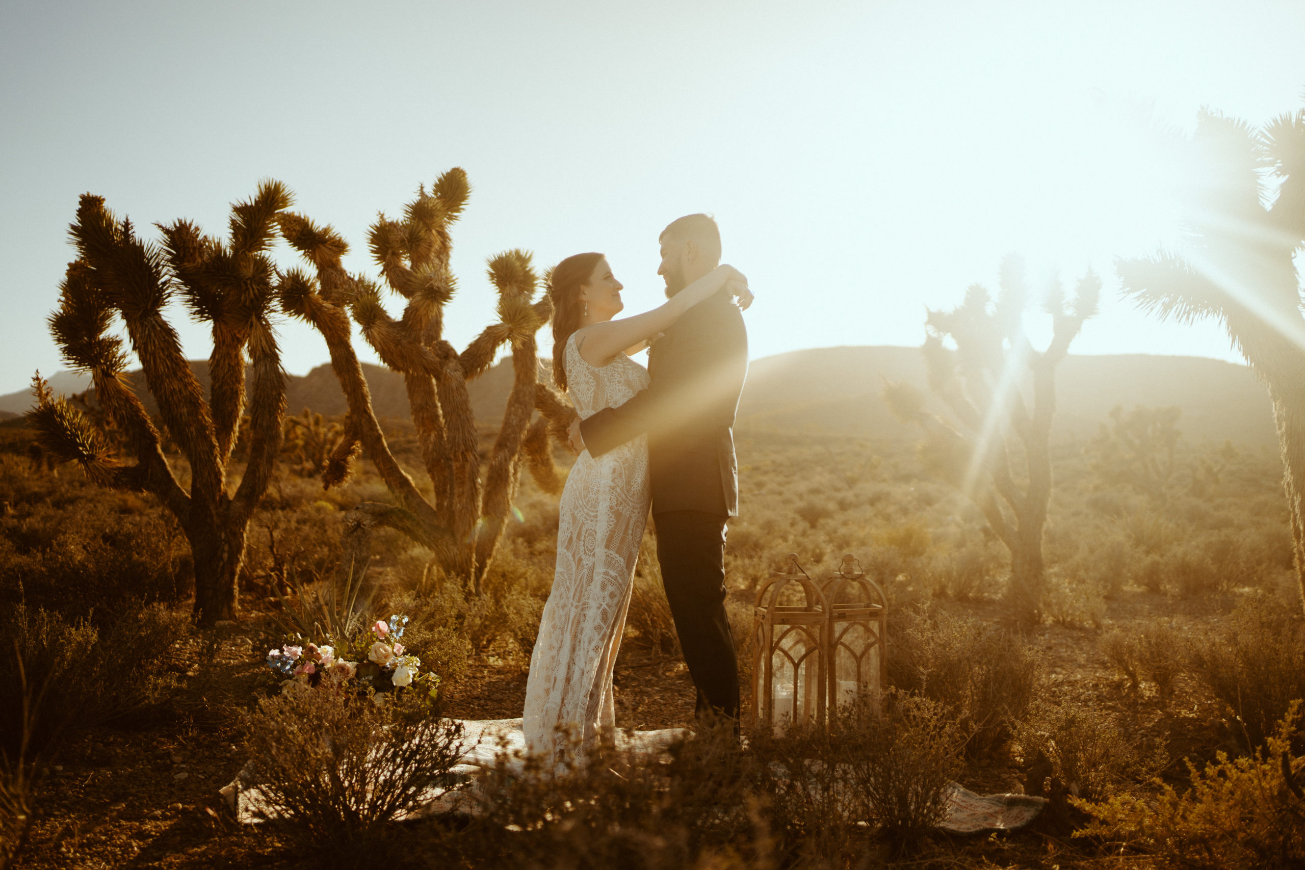 Newlyweds enjoying a moment with Joshua trees surrounding them for our Joshua Trees in Las Vegas? No Way Blog 