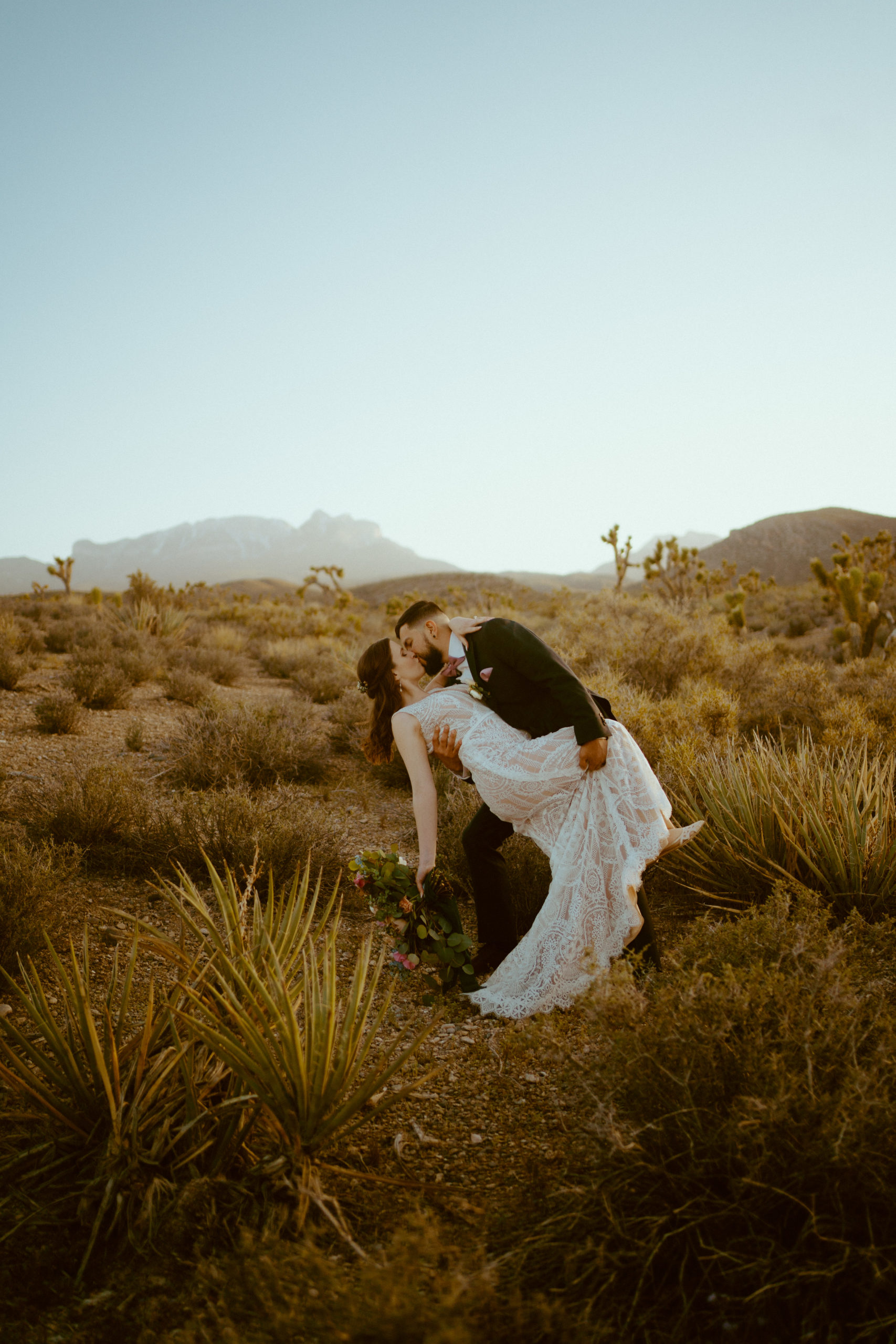 Newlyweds dancing in the desert 