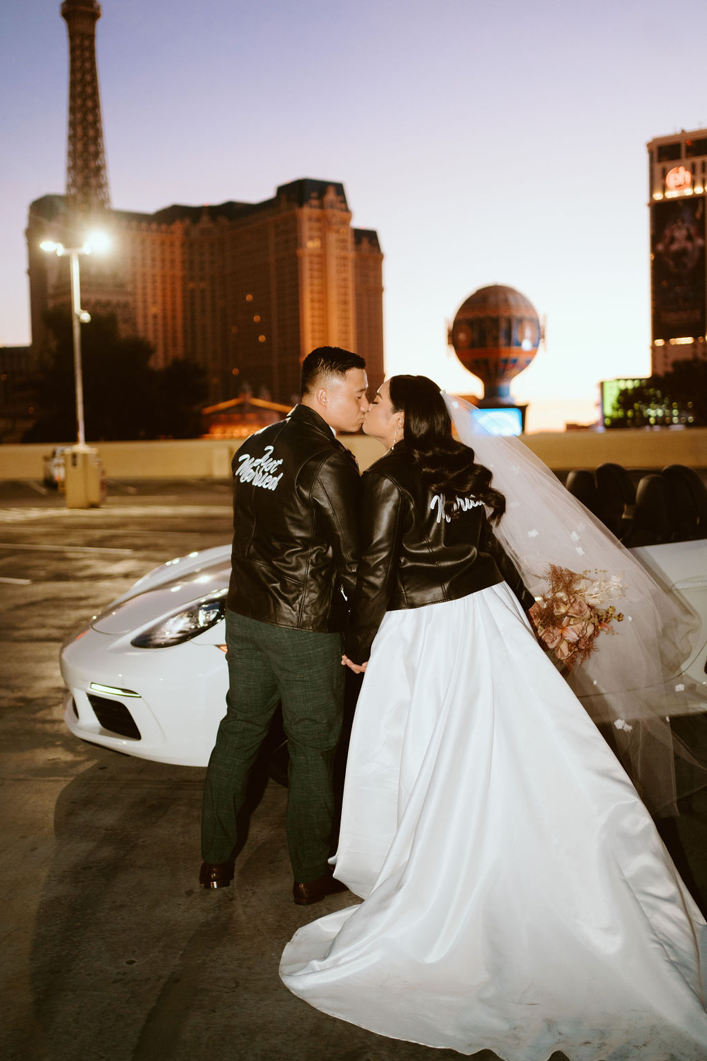 Couple in custom black leather jackets kissing in Las Vegas before leaving in convertible and eloping