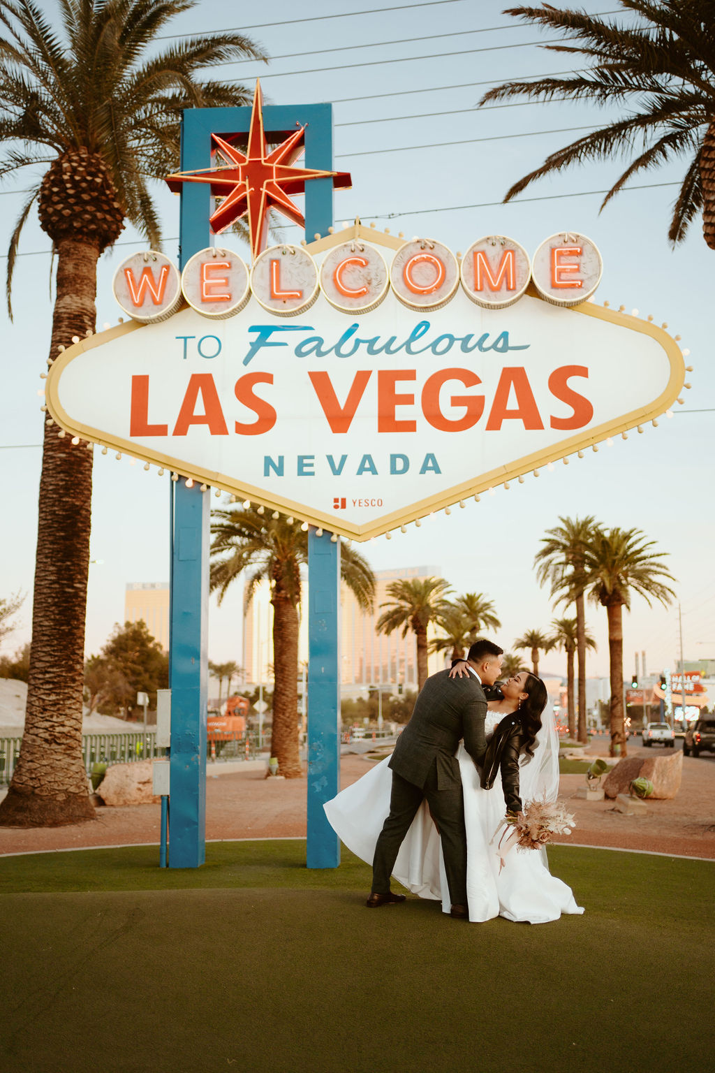 Bride being dipped by Groom in front of Welcome to Fabulous Las Vegas Nevada Sign during Las Vegas Highlights & Desert Elopement