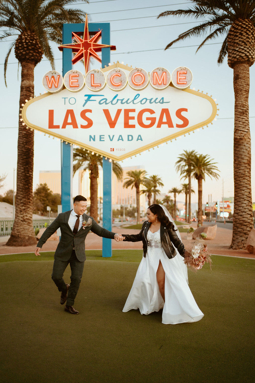 Bride and Groom laughing in front of Welcome to Fabulous Las Vegas Nevada Sign during Las Vegas Highlights & Desert Elopement