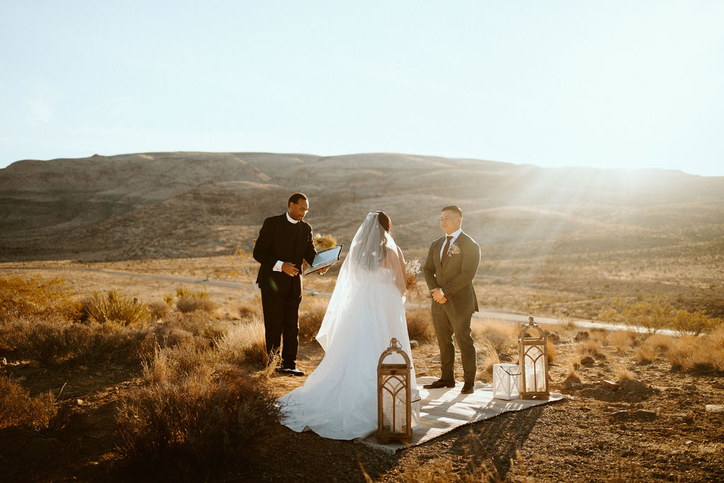 Couple getting married as sun rises at Red Rock in Las Vegas Highlights & Desert Elopement