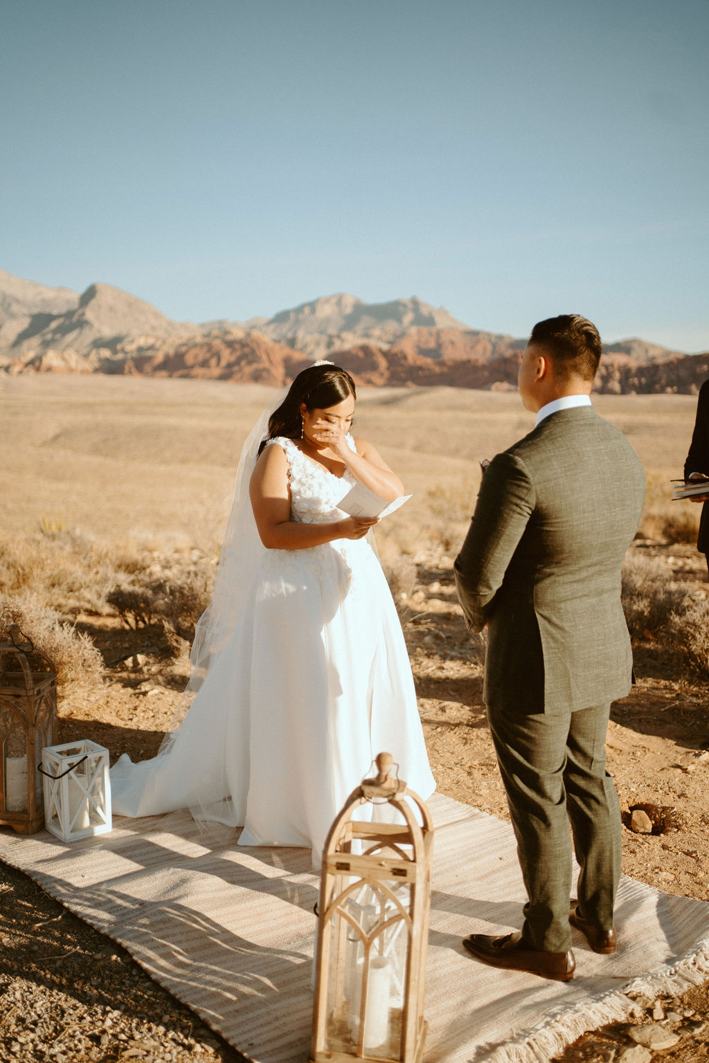 Bride crying while reading her vows to groom in red rock canyon outside of Las Vegas 