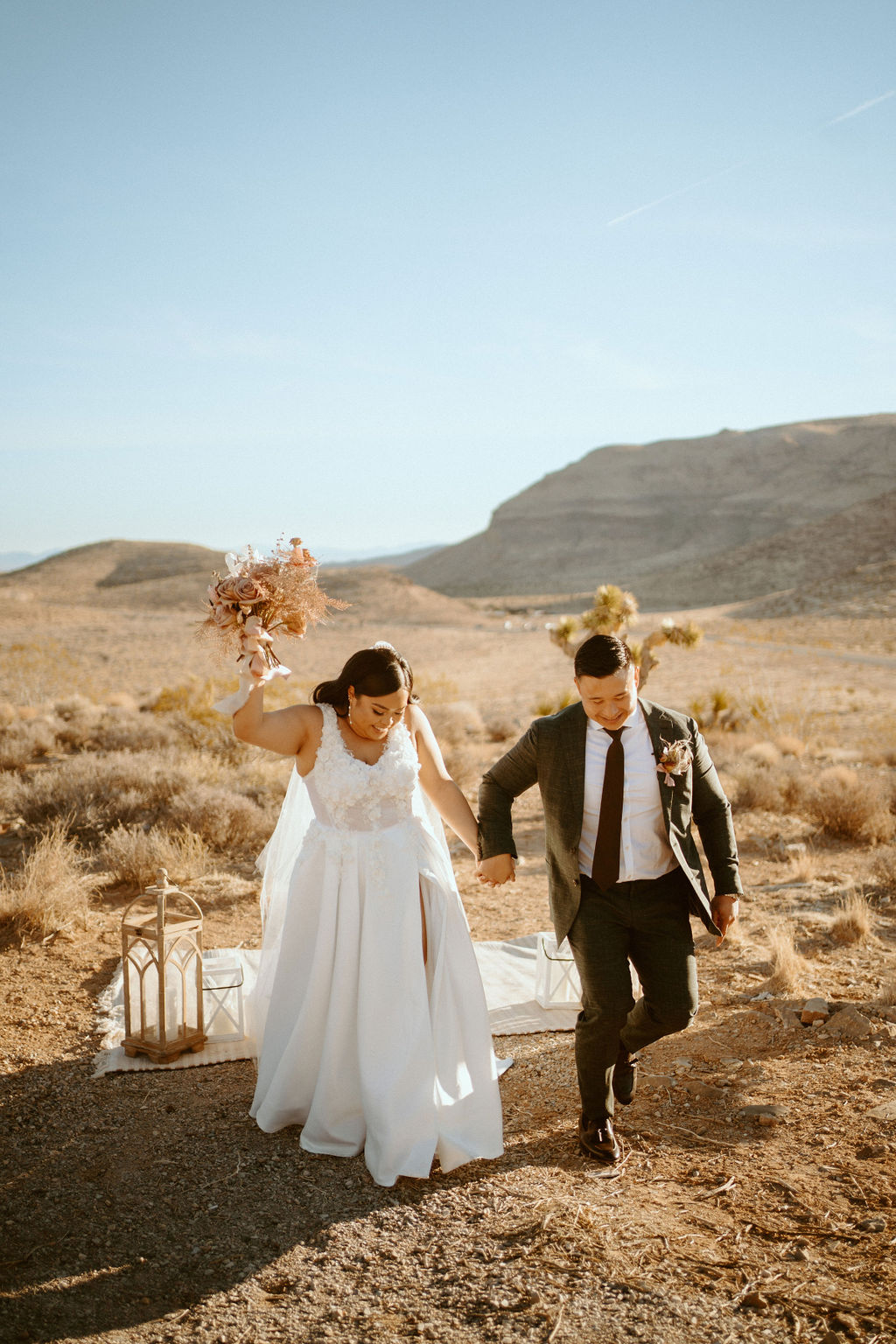 Bride holding up bouquet and walking with groom in celebration after eloping 