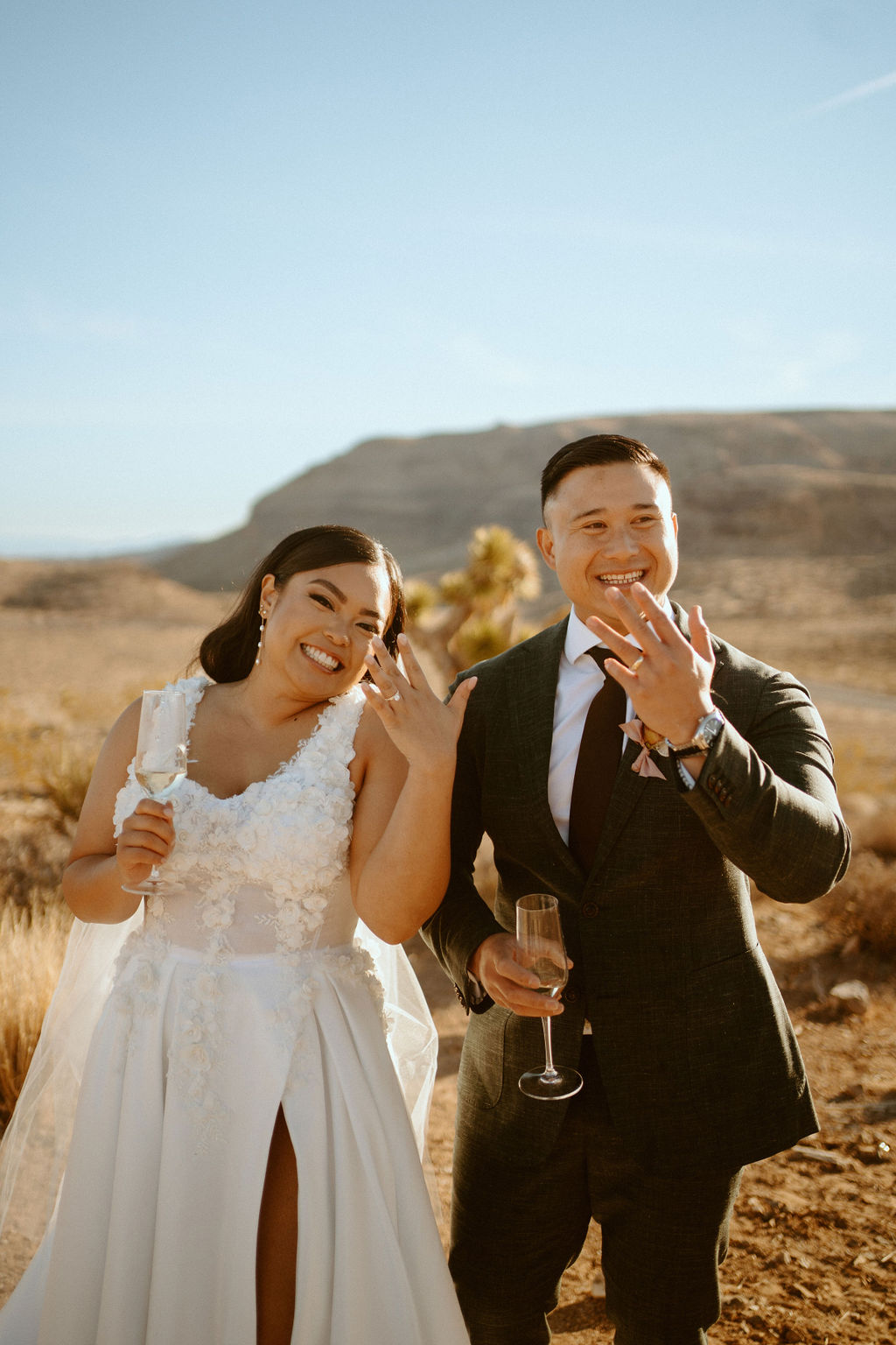Newlyweds showing rings after getting married in Las Vegas desert 