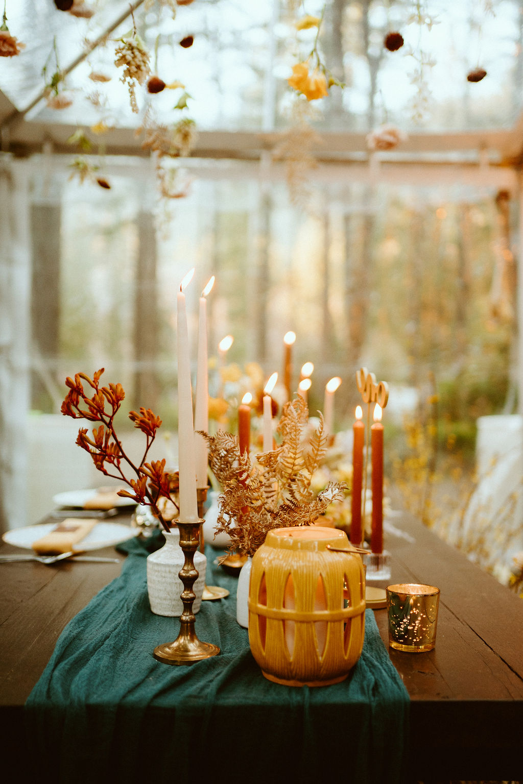 Dried floral arrangement and candles on guest tables