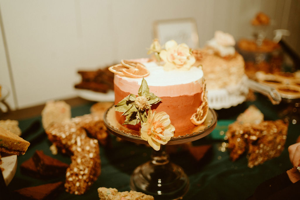 Loloma Lodge Retro Whimsical Micro-Wedding. One tier ombre wedding cake covered in florals and dried orange slices