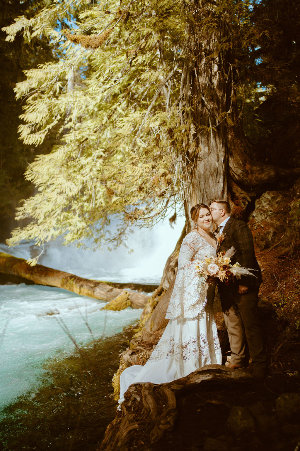 Couple standing in front of the waterfall 