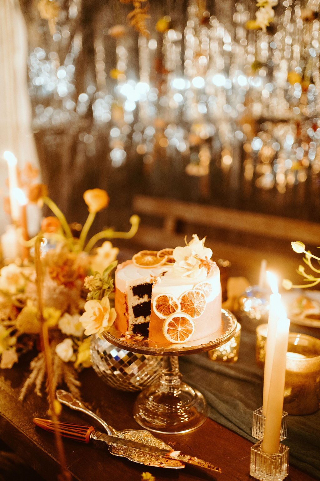 Ombre cake with dried slices of oranges and florals cut to eat 