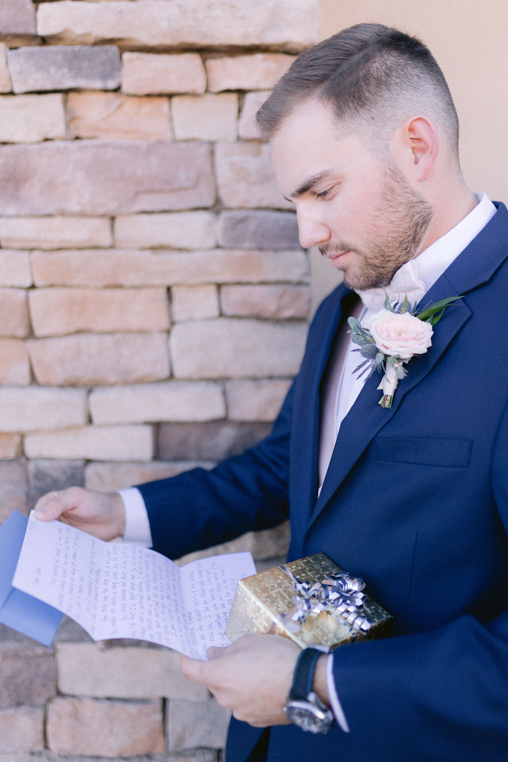 Groom reading a personalized letter from the bride. 