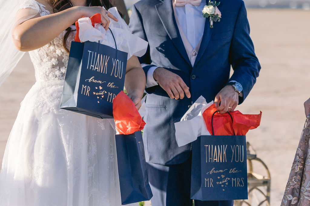 Navy Blue & Blush Pink Micro-Wedding the bride and groom have thank you gifts for their wedding party to give out. 