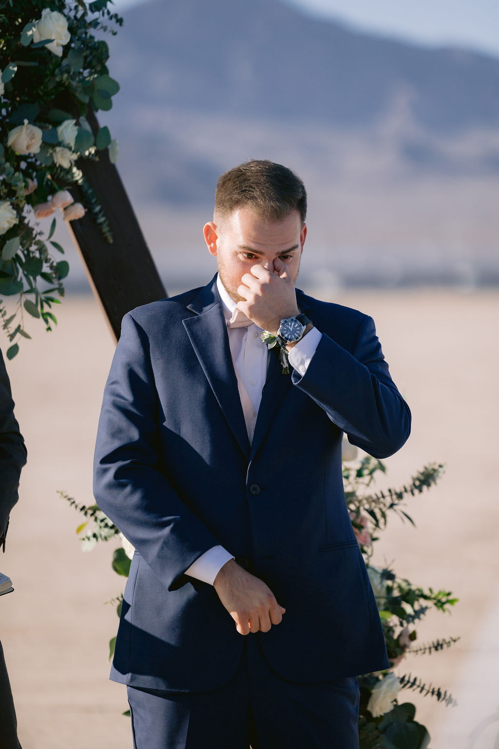 Navy Blue & Blush Pink Micro-Wedding groom wiping his eyes as he sees his bride for the first time. 