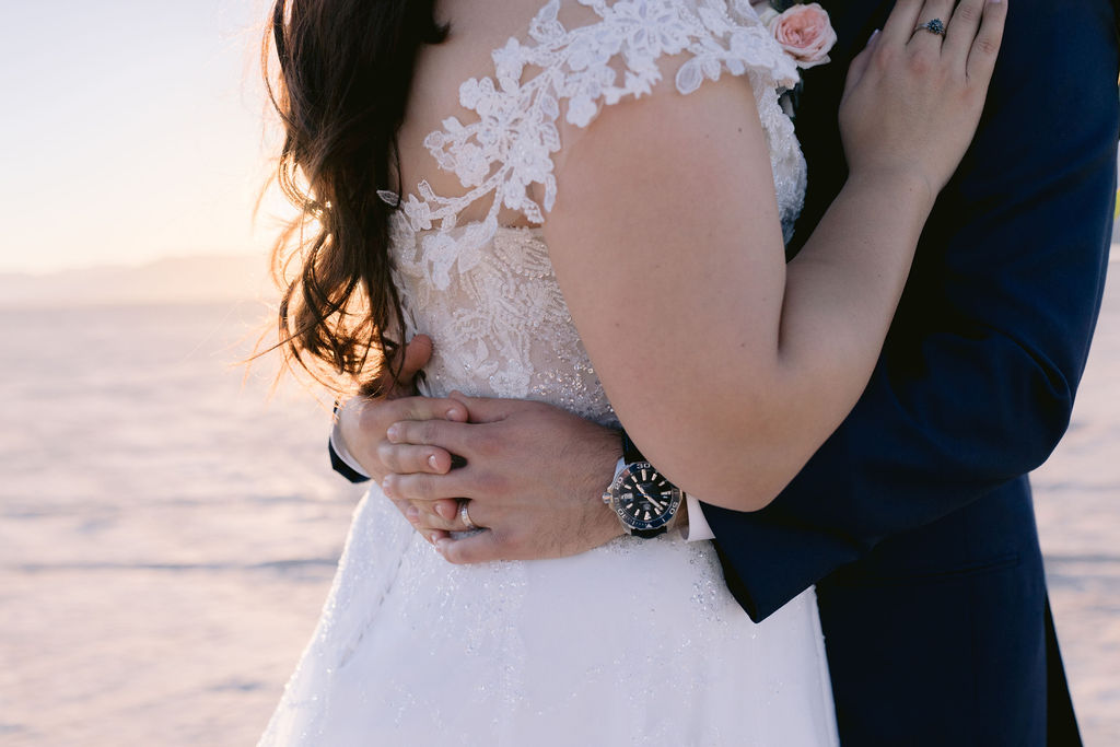 Navy Blue & Blush Pink Micro-Wedding close up of the groom holding his bride. 