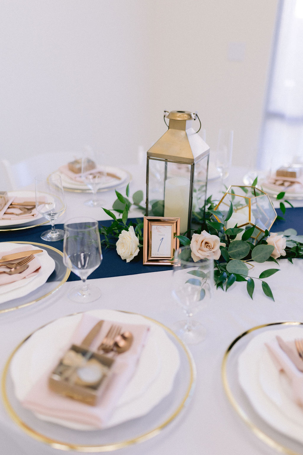 Navy Blue & Blush Pink Micro-Wedding reception tables with table number and wine glasses. 