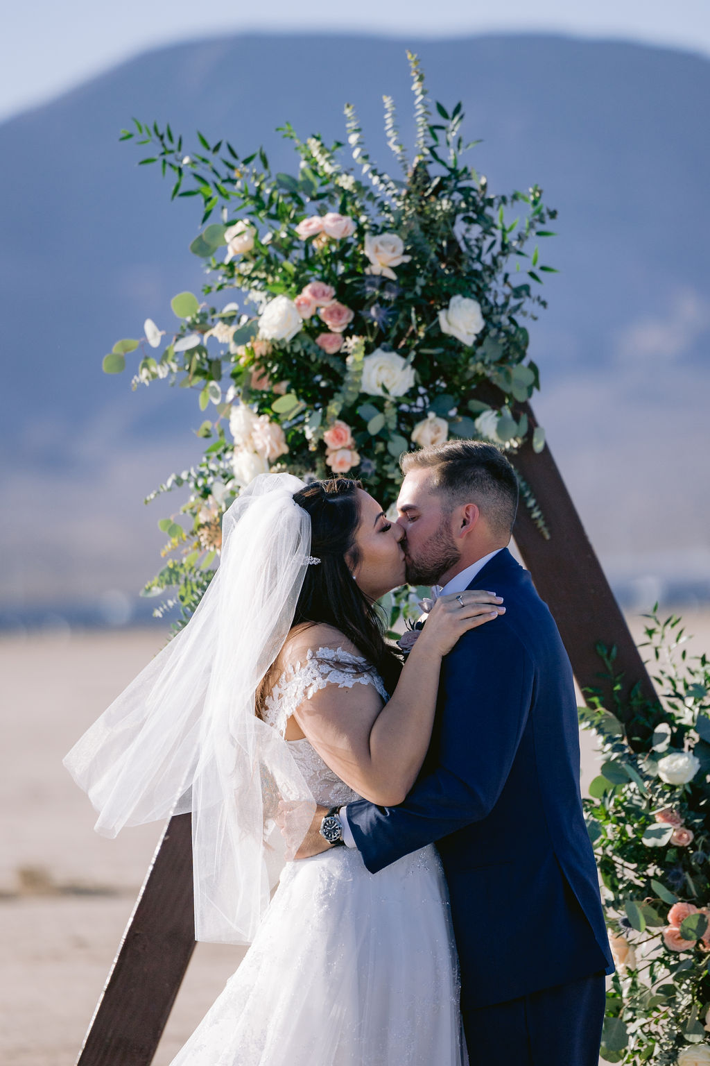 Navy Blue & Blush Pink Micro-Wedding Bride and groom say I do and share their first kiss. 