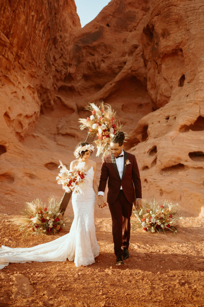 Romantic Mauve & Desert Hues Elopement bride and groom walk down the isle.