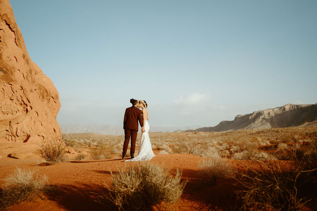Bride and Groom kissing looking out at the Valley of Fire. 