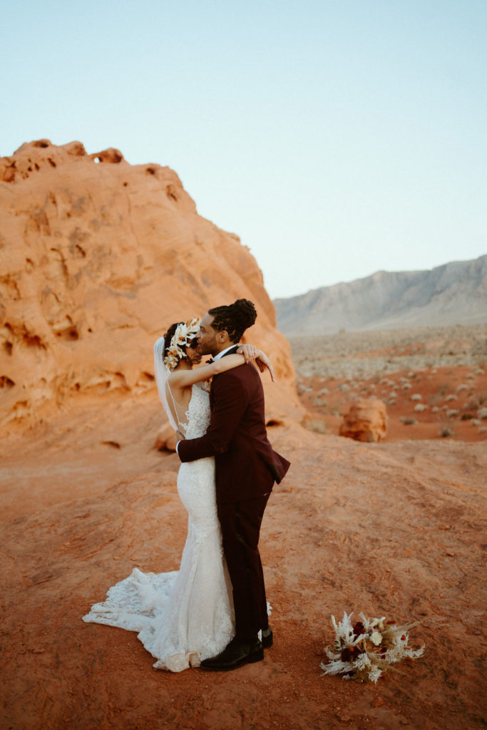 Romantic Mauve & Desert Hues Elopement Bride and groom slow dance in the desert in the Valley of Fire. 