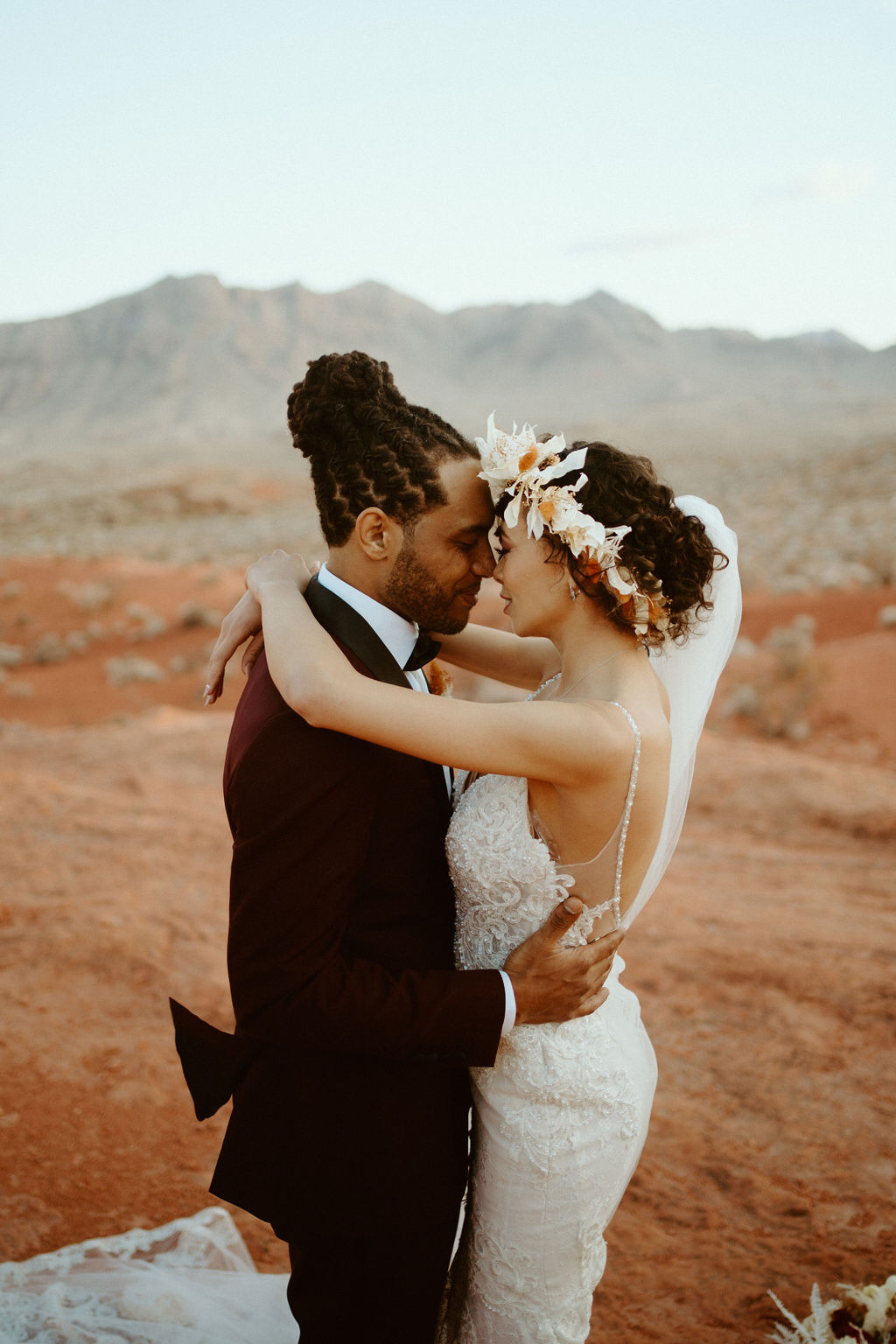 Romantic Mauve & Desert Hues Elopement close up of the bride and groom holding each other close in the Valley of Fire. 