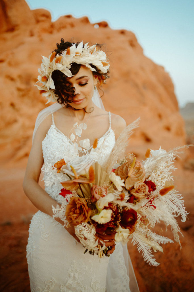 Close up of bride with gorgeous head piece and desert floral bouquet. 