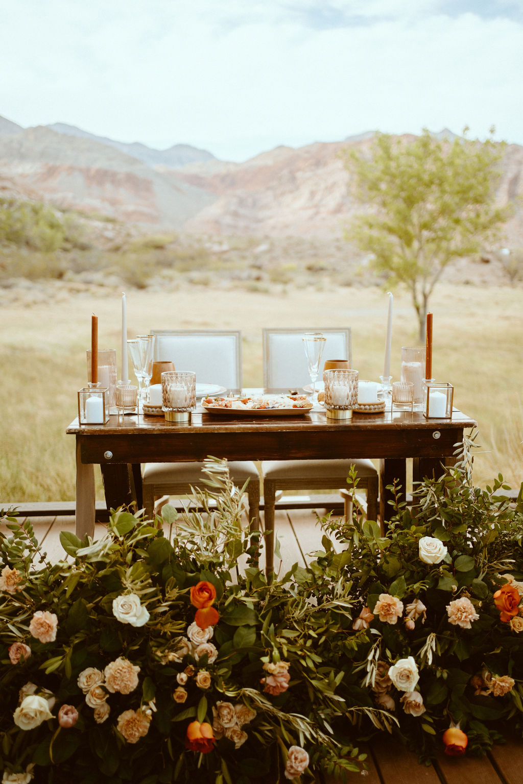 Rustic Boho Never Looked So Good! Decorated sweetheart table with Charcuterie set up for the couple. Their rustic floral ground arch now surrounding the sweetheart table. 
