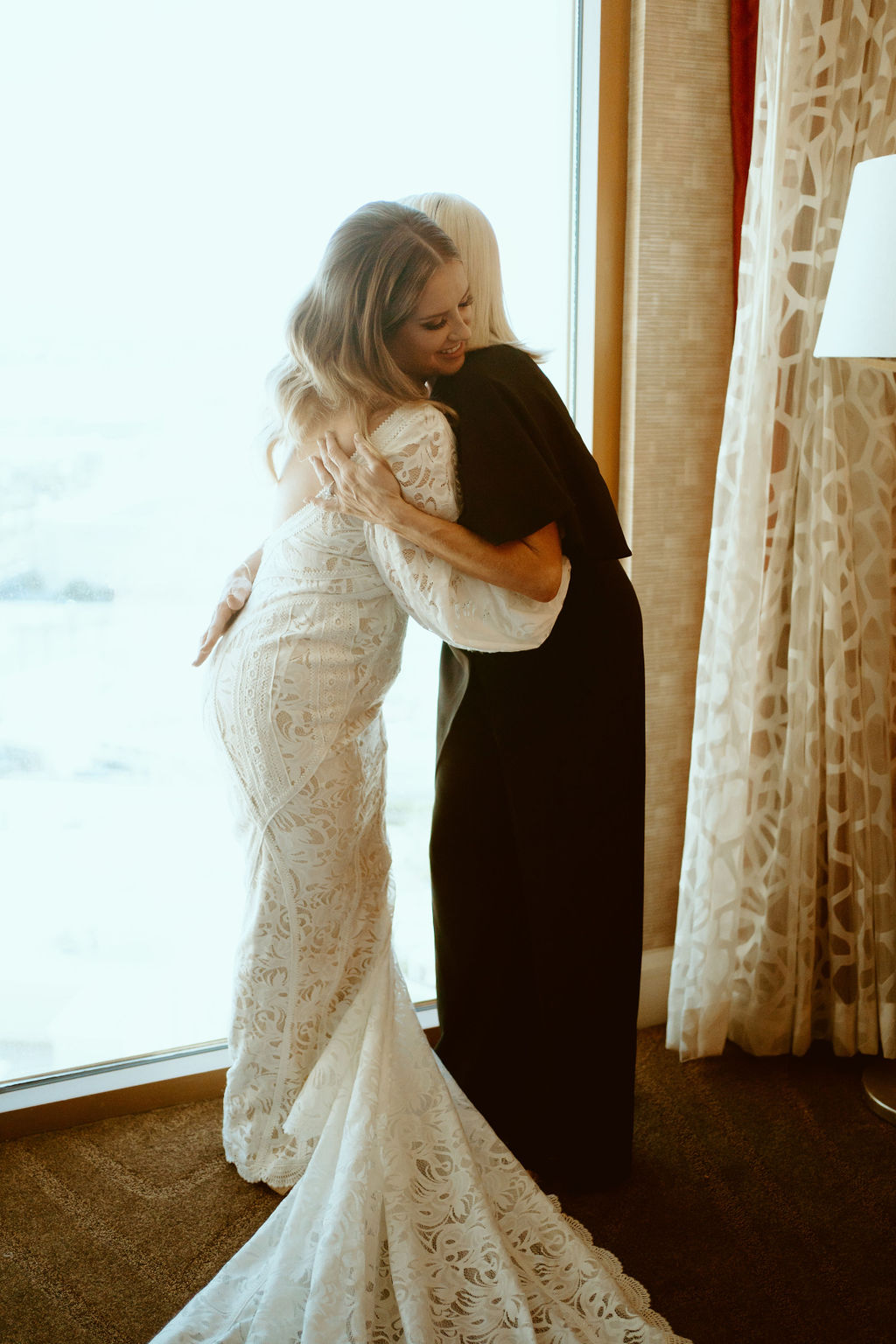 Rustic Boho Never Looked So Good! Bride and her mother embrace in a hug.