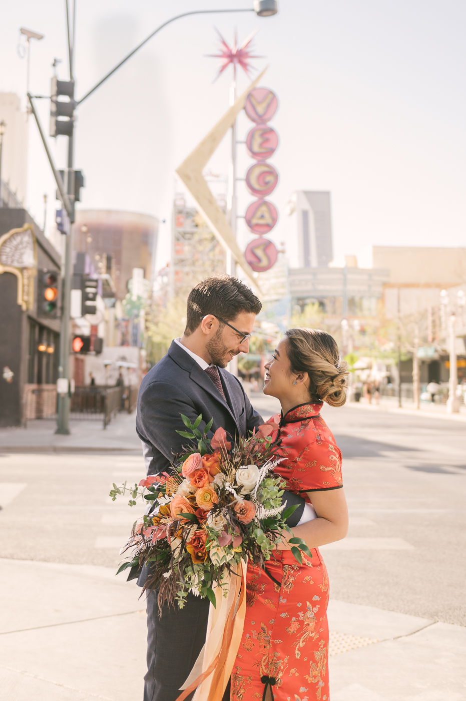 Two Bridal Outfits are Better than One! Newlyweds pose downtown in front of the vintage Vegas sign. 