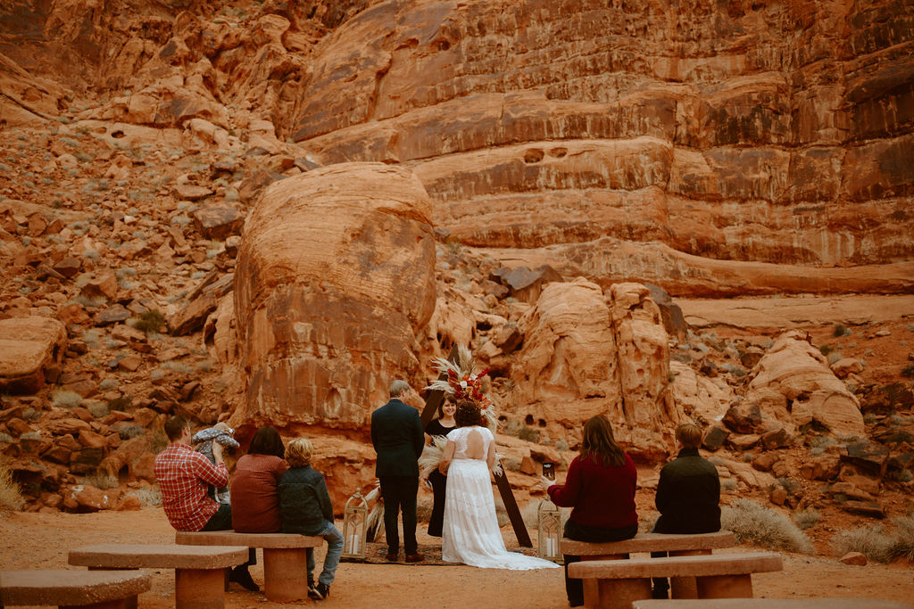 Bride and Groom starting elopement ceremony with dramatic red rocks in background