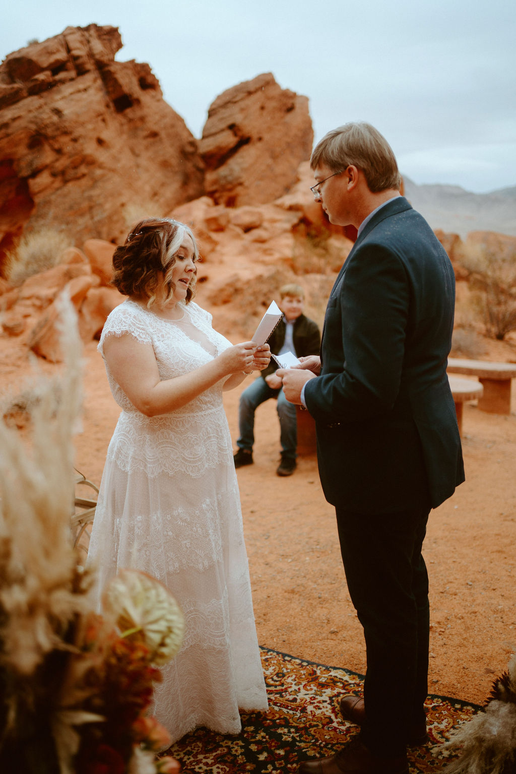 Bride Reading Vows to Groom at Visitor Center Valley of Fire Elopement