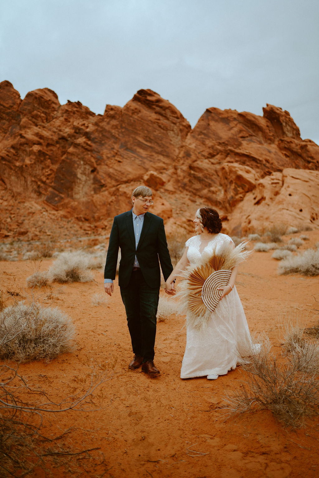 Newlyweds walking through Valley of Fire after Elopement 