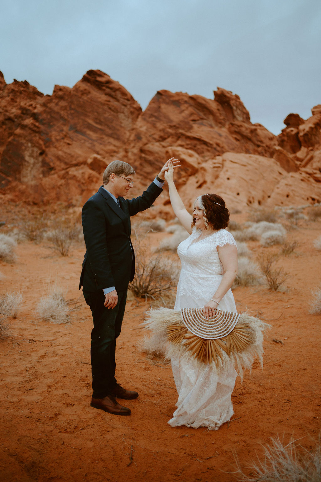 Newlyweds dancing in Las Vegas Desert with Dramatic Red Rocks 