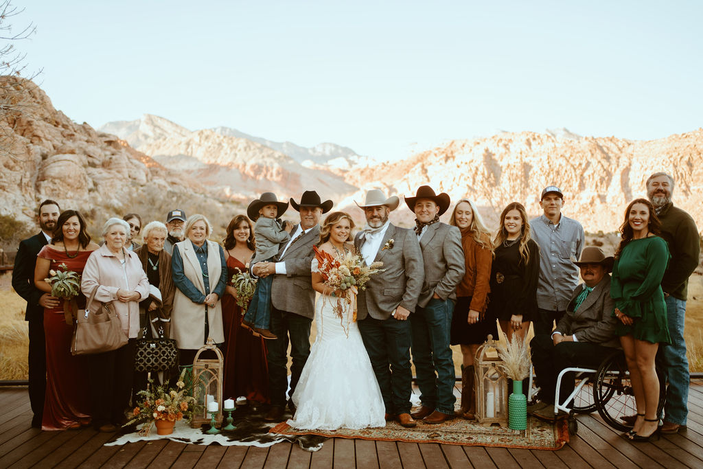 Family and Friends with Newlyweds and Red Rock Canyon in the background for Western Inspired Turquoise Boho Elopement 