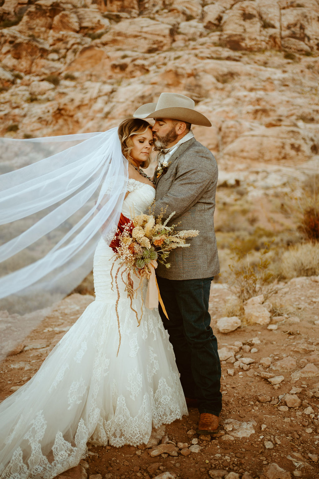 Groom Kissing Bride's Cheek after Western Inspired Turquoise Boho Elopement 