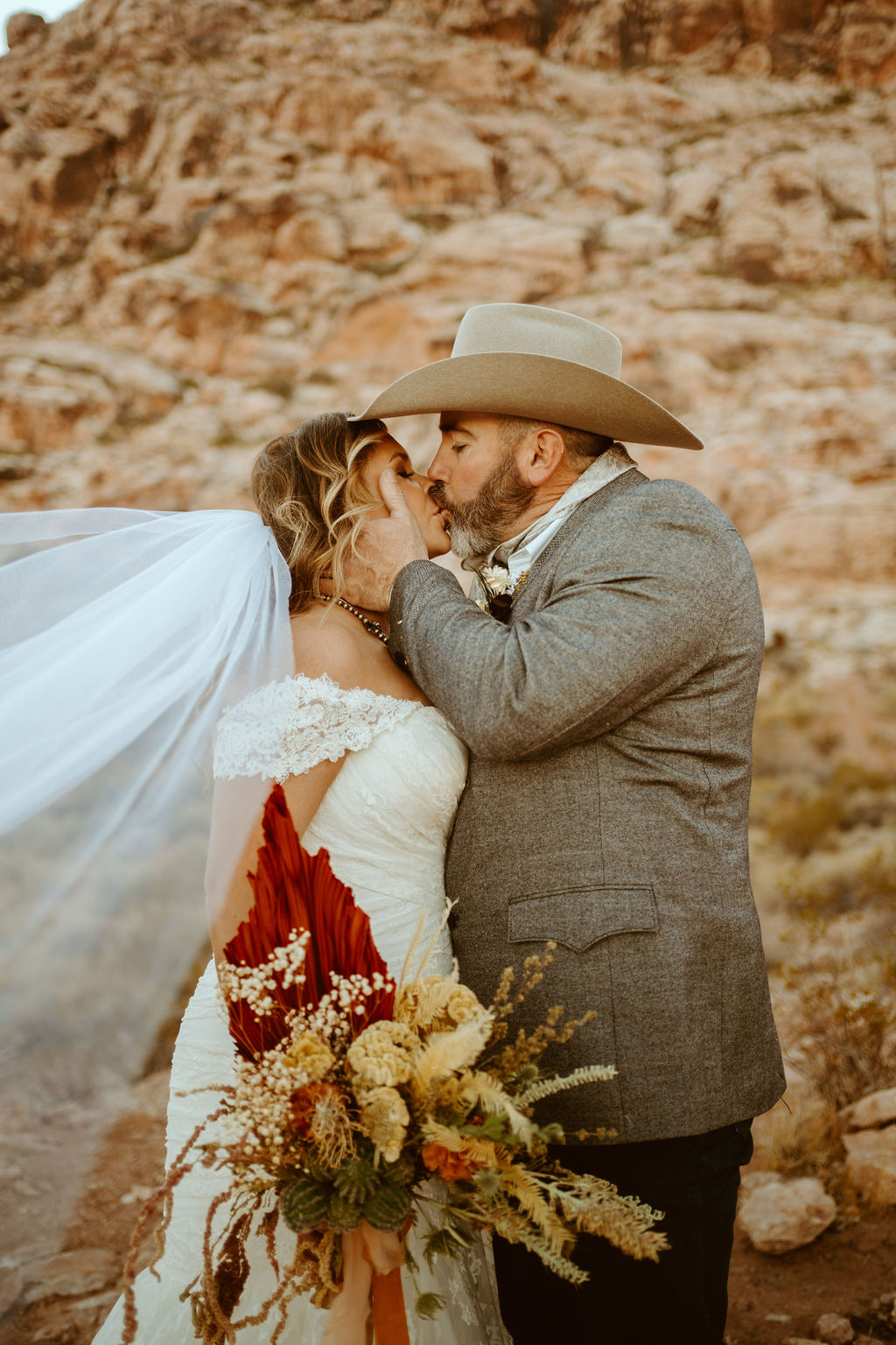 Bride and Groom Kissing in Red Rock Canyon after getting Married 