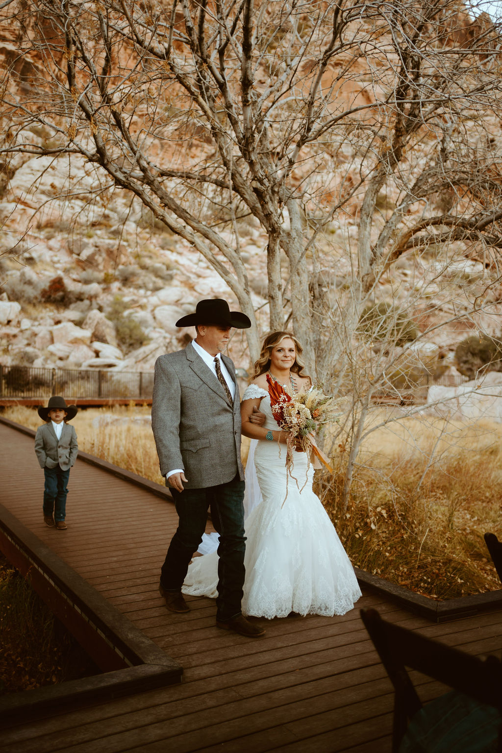 Bride walking down the Aisle in Western Inspired Turquoise Boho Elopement at Red Rock Canyon 