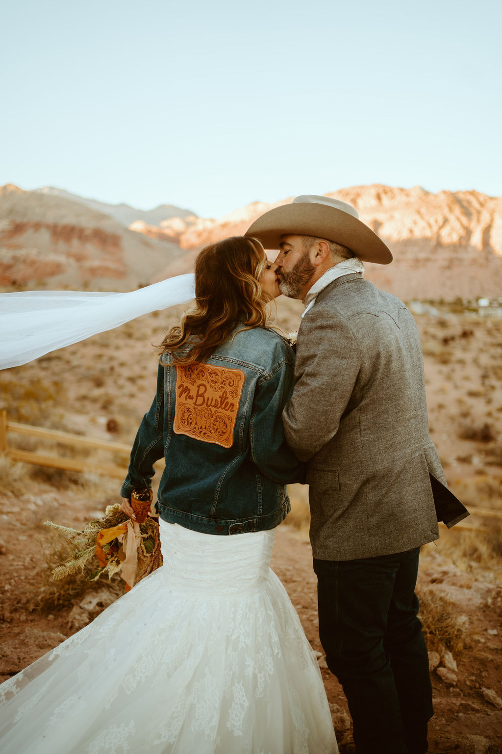 Bride in Custom Jean Jacket with Groom in Desert after getting Married 