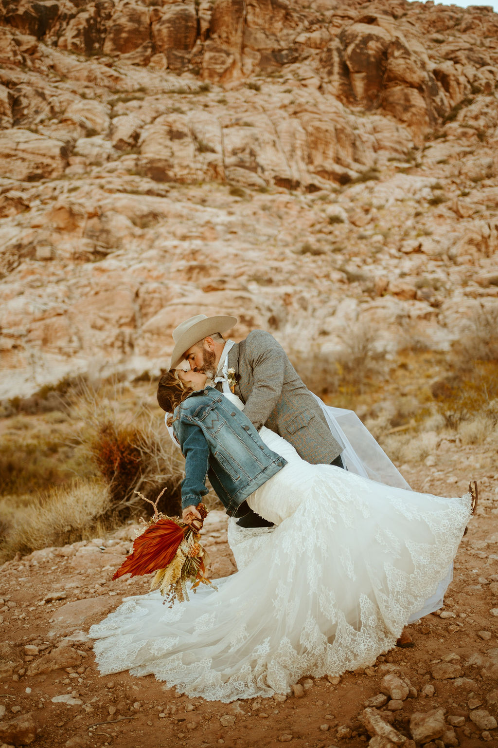 Groom dipping Bride during Western Inspired Turquoise Boho Elopement 