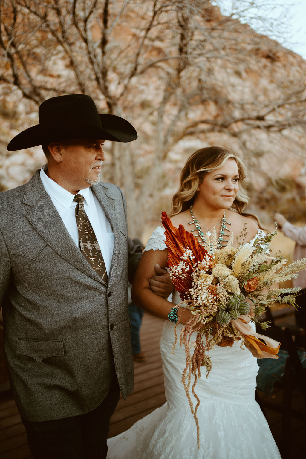 Bride with dried floral desert bouquet walking down aisle for at Red Rock Canyon 