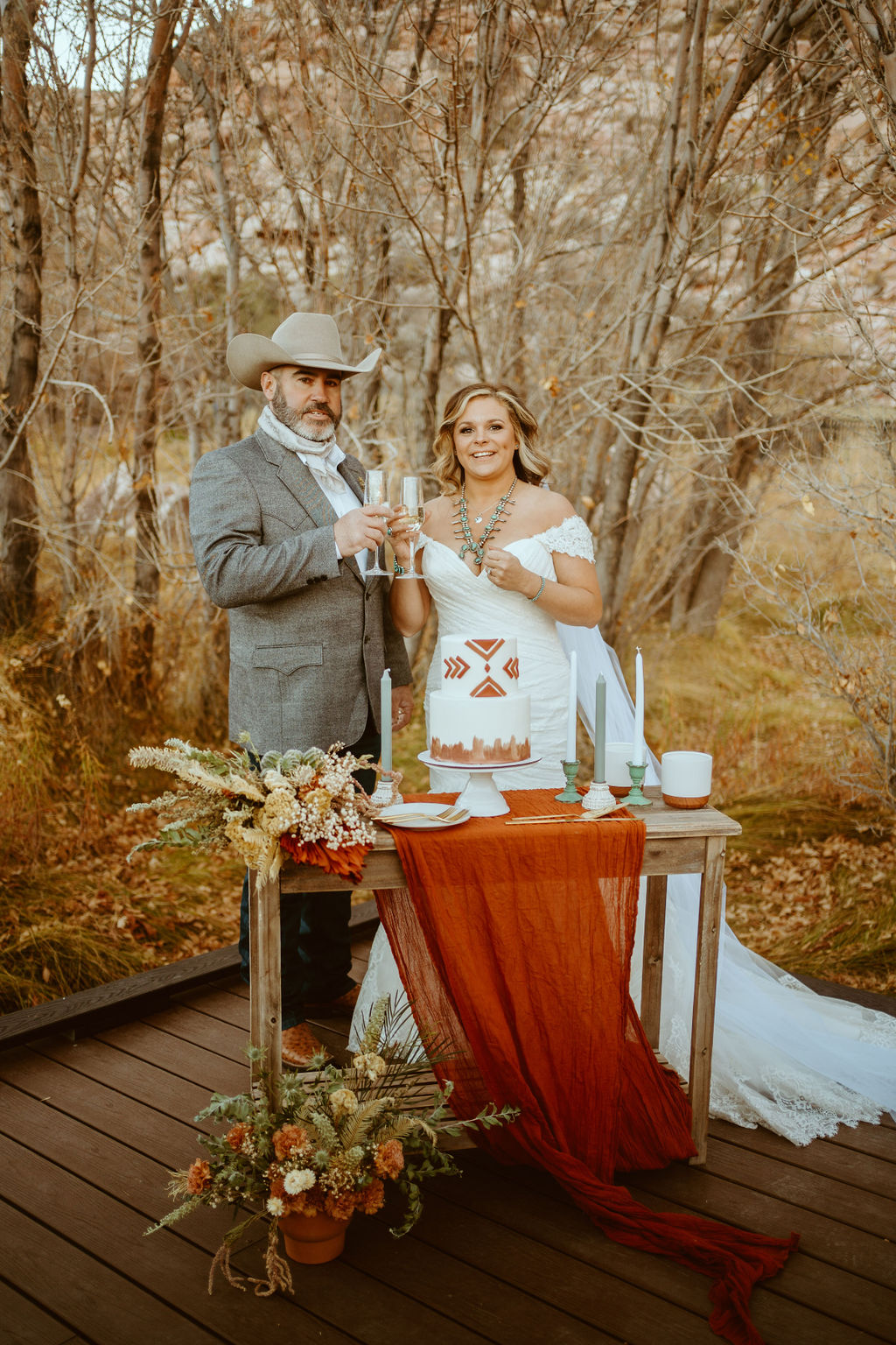 Newlyweds having Champagne Toast before Cutting Caking during Western Inspired Turquoise Boho Elopement 